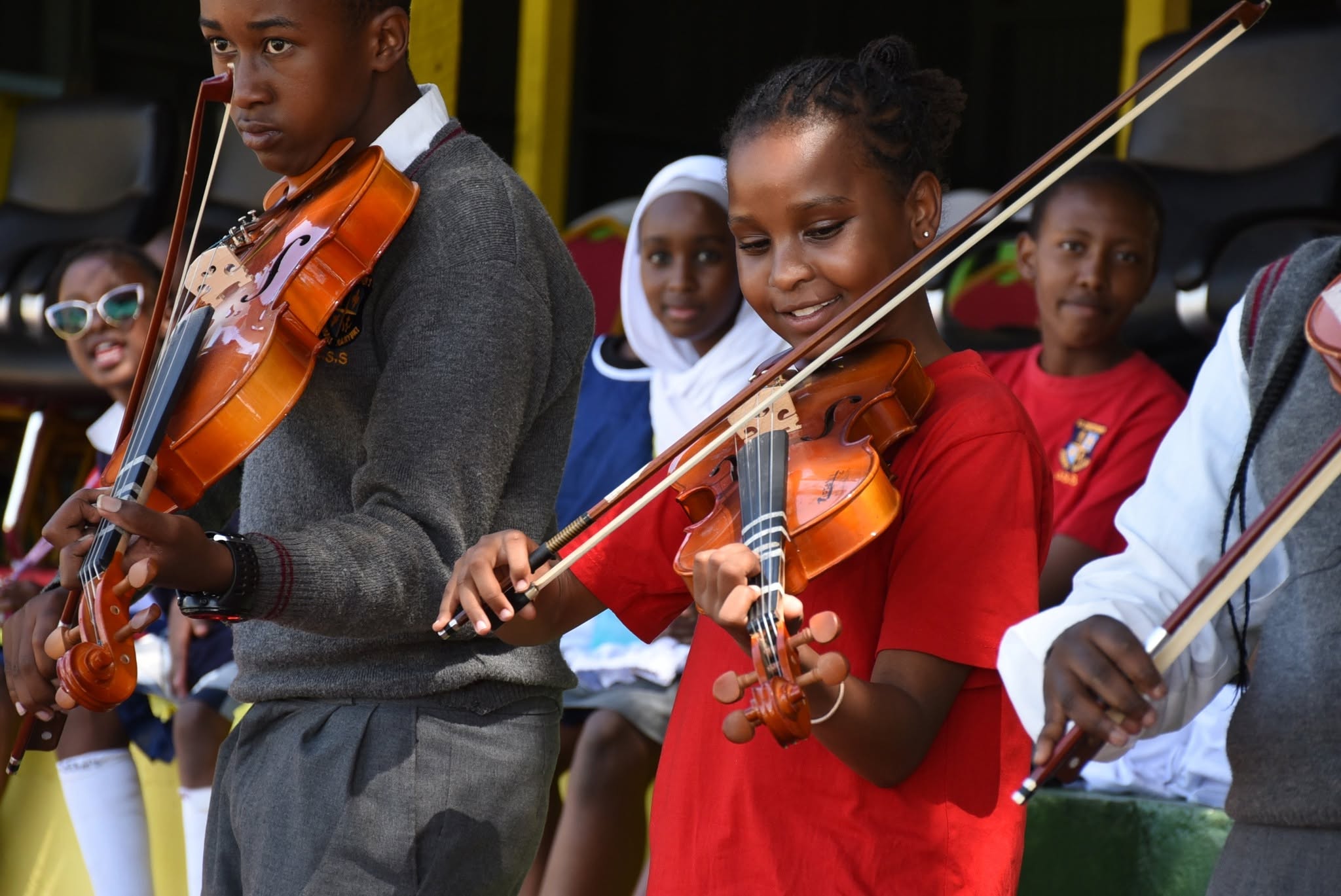 Students playing violin in the school string ensemble