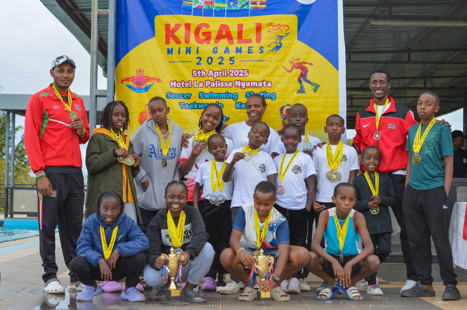 Students with medals and trophies at the Kigali Mini Games