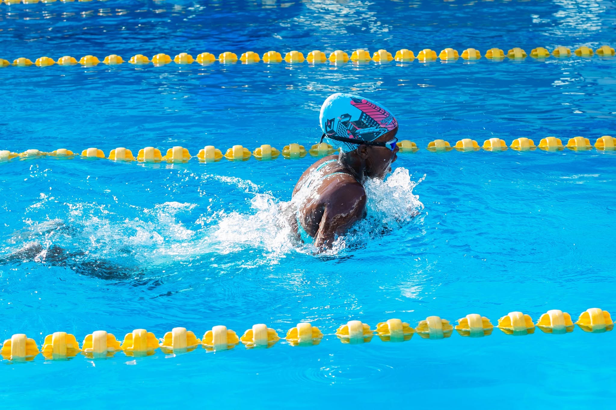 A swimmer racing breaststroke
